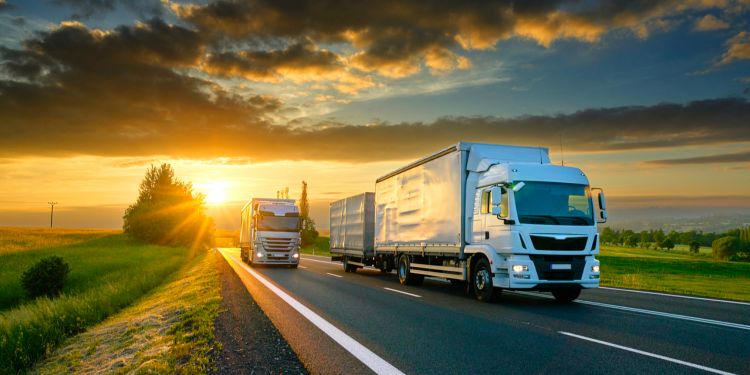 Heavy commercial trucks travelling on a highway